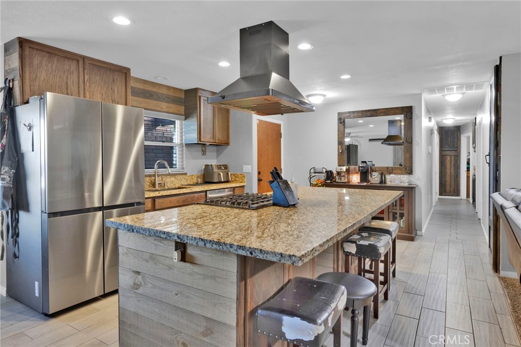 18608 Cocqui Road Apple Valley, CA 92307 - Photo 5 of 30 a kitchen with stainless steel appliances granite countertop a table chairs refrigerator and sink