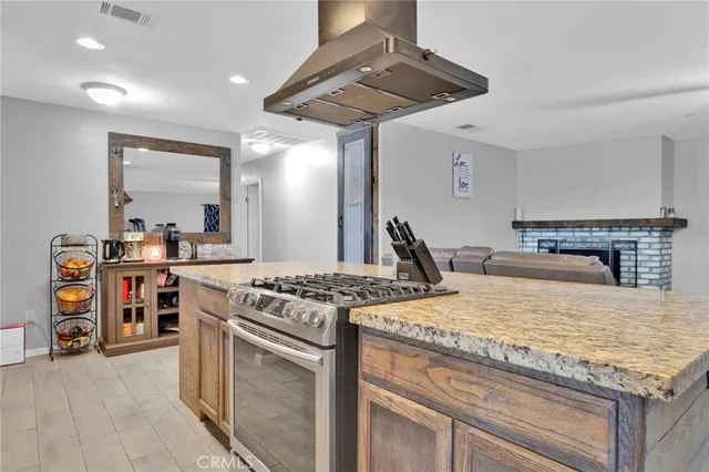 a kitchen with a stove and a wooden floor