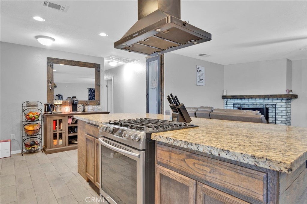 18608 Cocqui Road Apple Valley, CA 92307 - Photo 6 of 30 a kitchen with a stove and a wooden floor