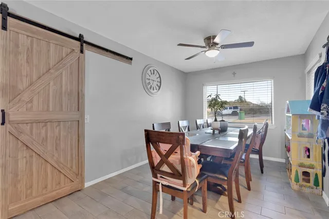 a view of a dining room with furniture and a window