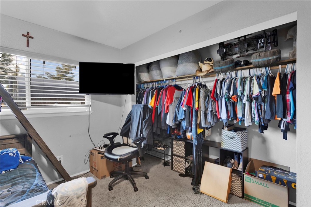 18608 Cocqui Road Apple Valley, CA 92307 - Photo 10 of 30 a view of walk in closet with clothes and shoes