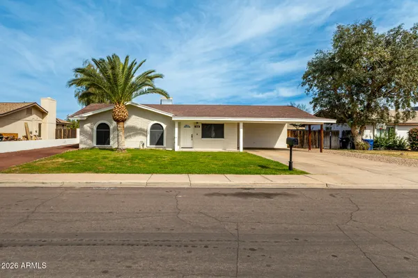 a house with palm tree in front of it