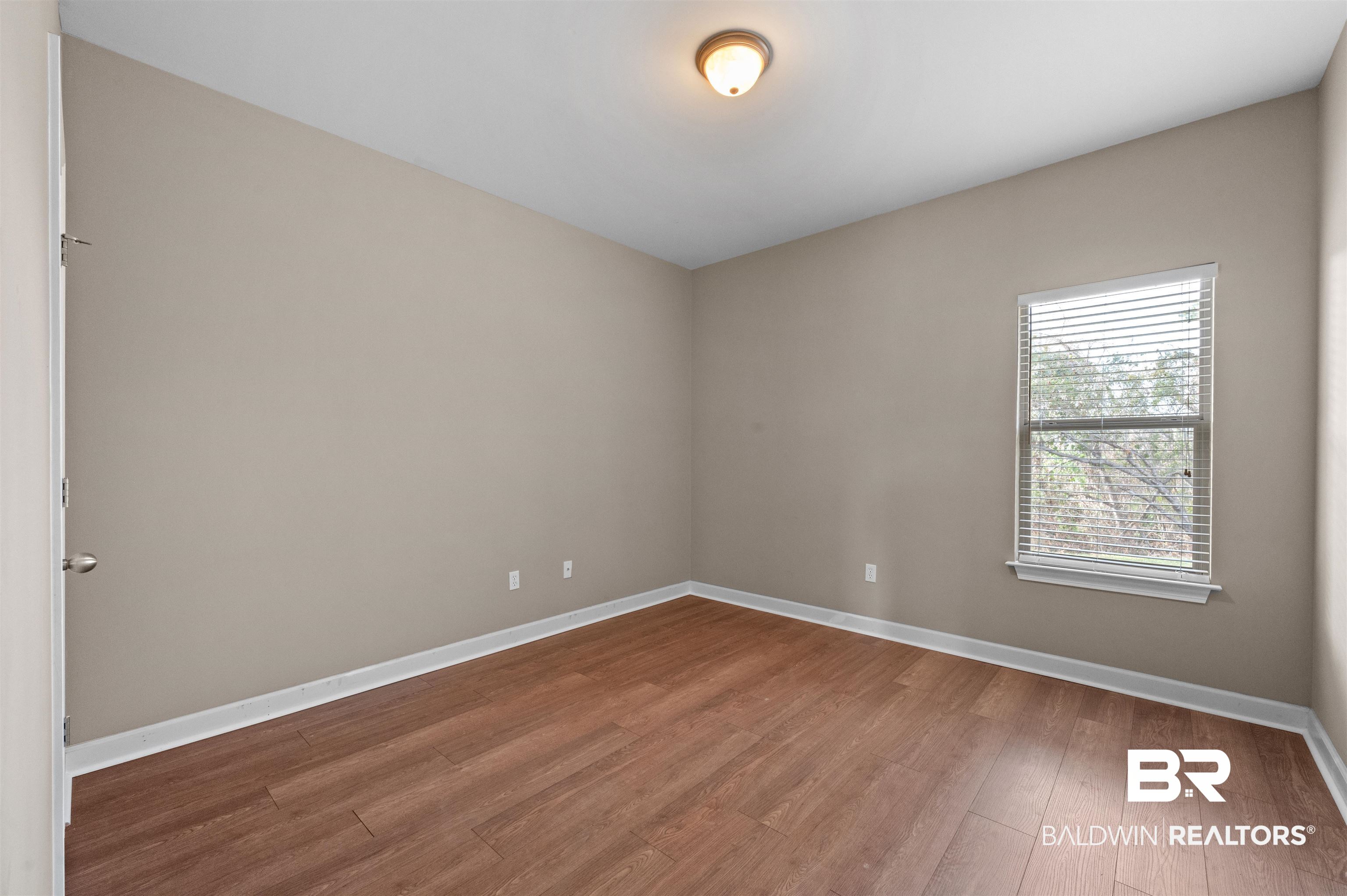 9381 Sable Court Daphne, AL 36526 - Photo 33 of 42 Empty room featuring baseboards and wood finished floors
