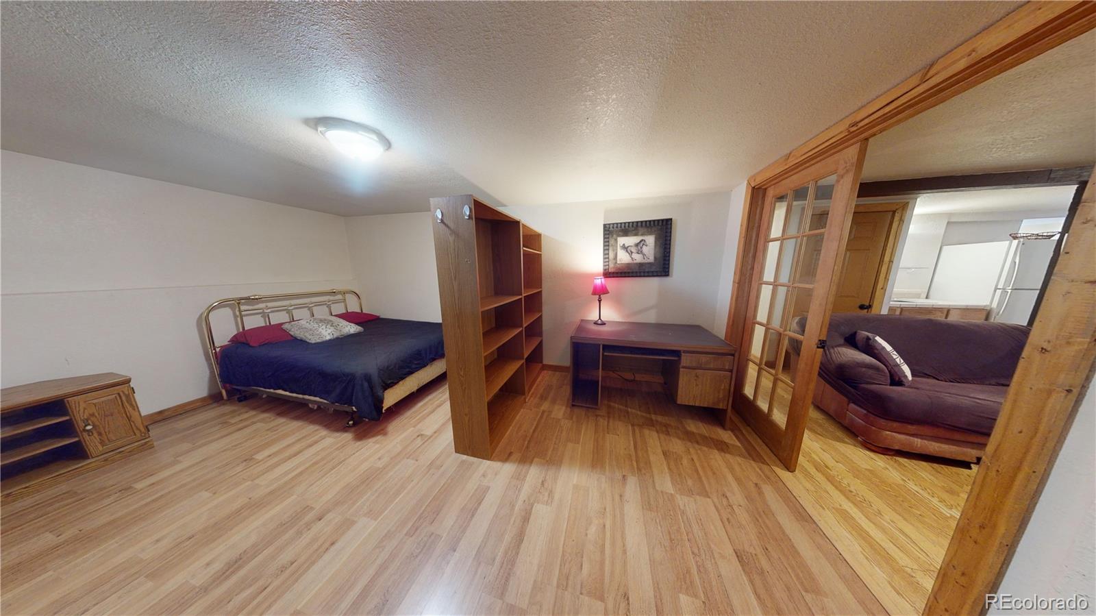 1011 Castle Ridge View Cripple Creek, CO 80813 - Photo 11 of 40 a living room with furniture and a wooden floor