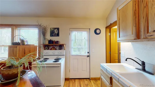 a kitchen with a sink and wooden cabinets