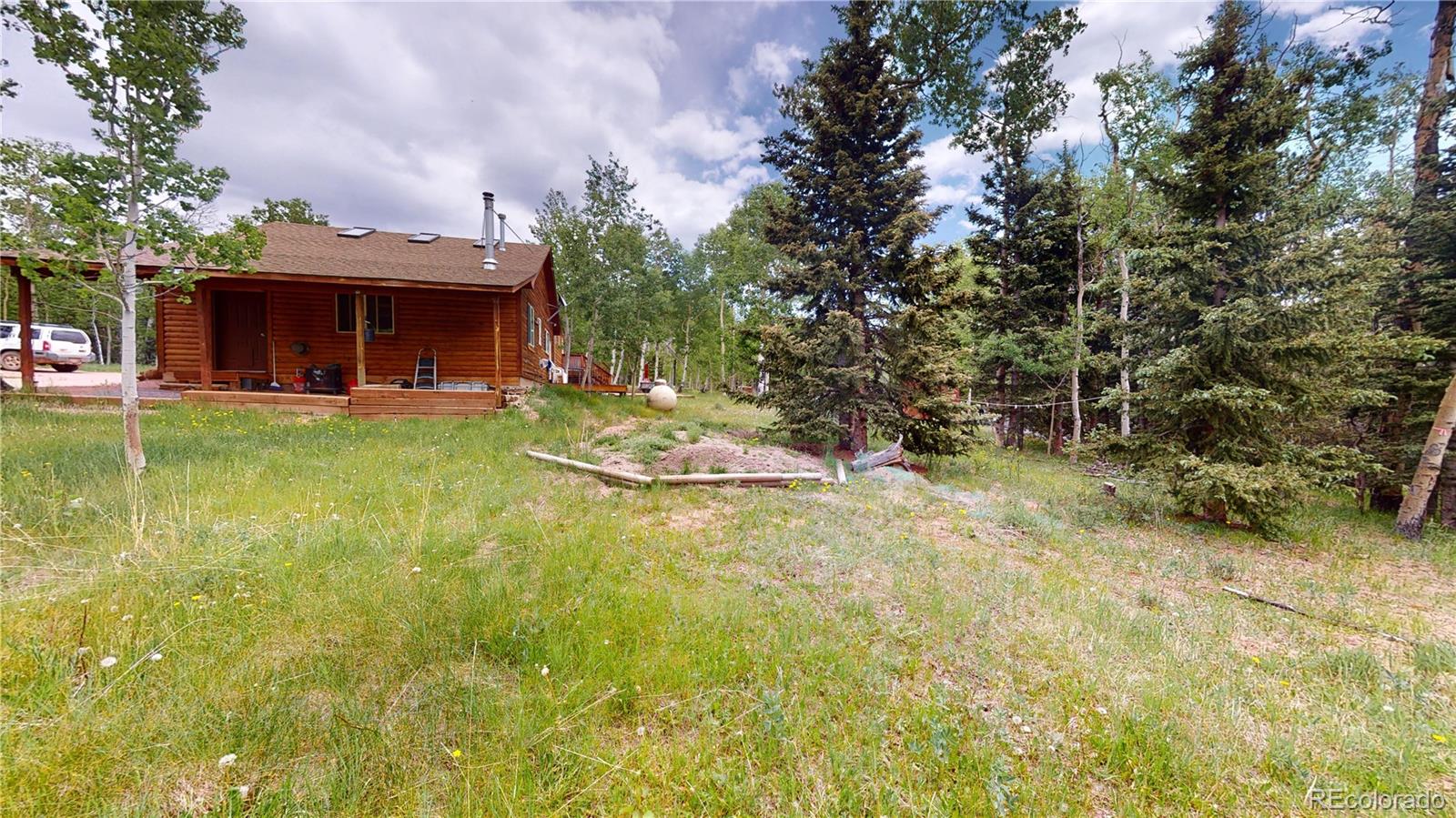 1011 Castle Ridge View Cripple Creek, CO 80813 - Photo 2 of 40 a view of a house with a yard garage and sitting area