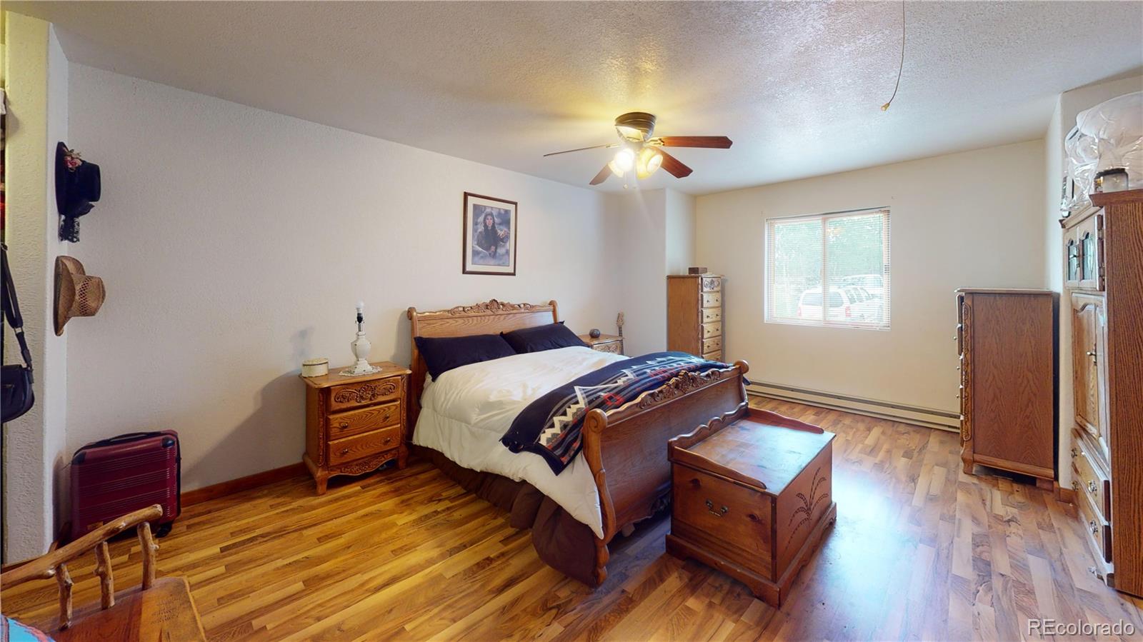 1011 Castle Ridge View Cripple Creek, CO 80813 - Photo 26 of 40 a bedroom with a bed and wooden floor
