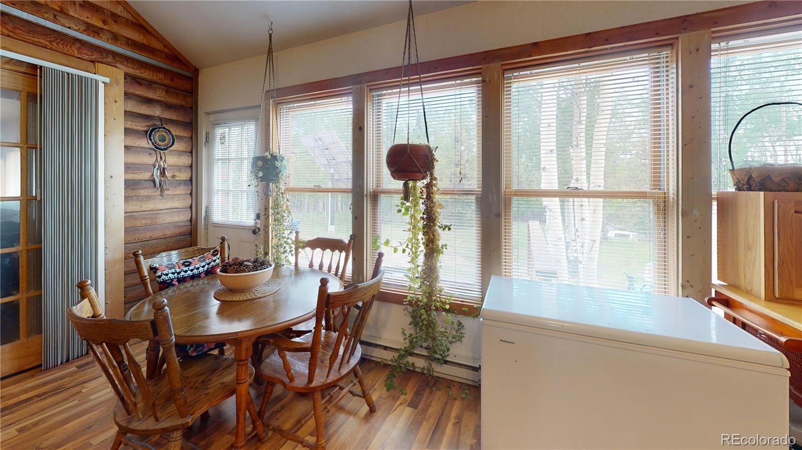 1011 Castle Ridge View Cripple Creek, CO 80813 - Photo 32 of 40 a view of a dining room with furniture and large windows