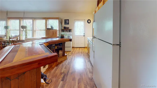 a view of a living room with furniture and wooden floor