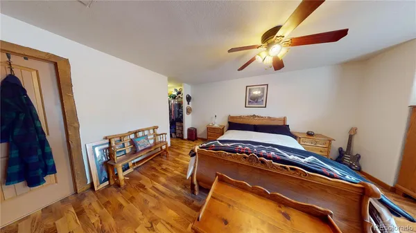 a bedroom with a bed and a mirror