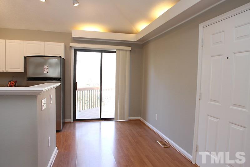 3449 Mill Run, Unit 3449 Raleigh, NC 27612 - Photo 4 of 12 a view of a kitchen with wooden floor and electronic appliances