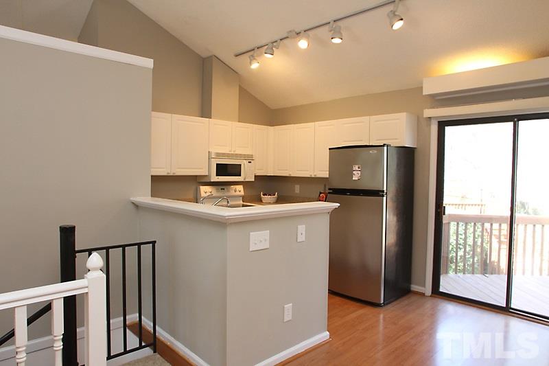 3449 Mill Run, Unit 3449 Raleigh, NC 27612 - Photo 5 of 12 a kitchen with stainless steel appliances a refrigerator and a stove top oven