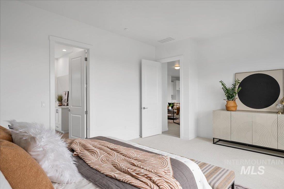1120 West Switchgrass Drive Meridian, ID 83642 - Photo 8 of 13 Carpeted bedroom with ensuite bath
