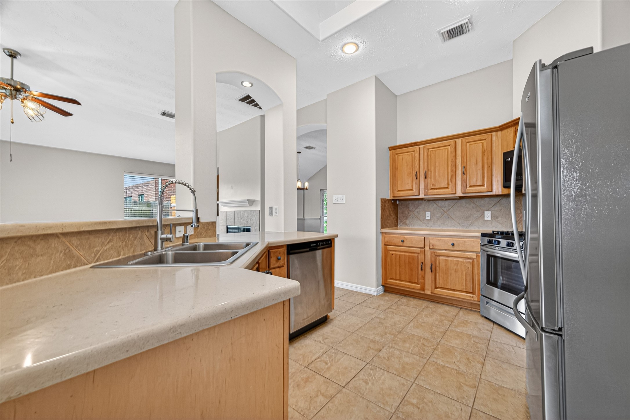 23914 Glengate Drive Spring, TX 77373 - Photo 18 of 49 a kitchen with stainless steel appliances granite countertop a sink stove and refrigerator