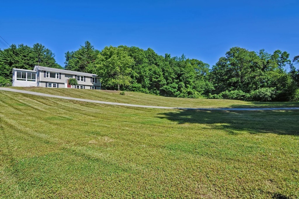 138 Leland Hill Road Sutton, MA 01590 - Photo 5 of 26 a view of a big room with a big yard and potted plants and large tree