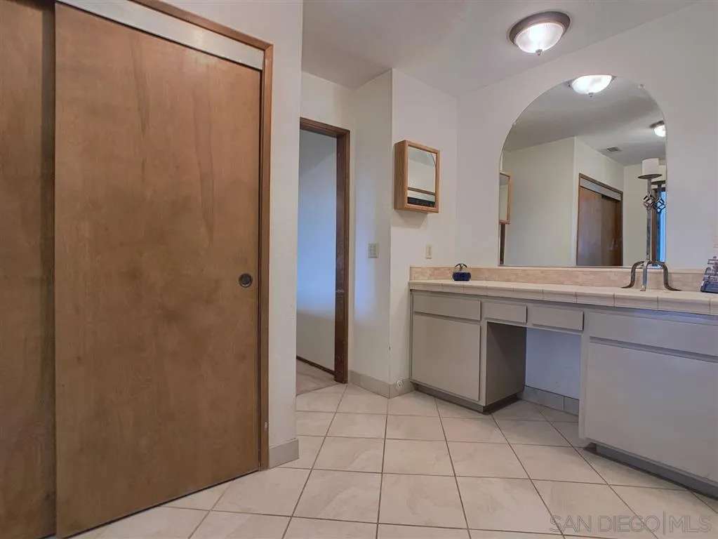 21152 Sutherland Dam Road Ramona, CA 92065 - Photo 12 of 25 a bathroom with a sink a mirror and a shower