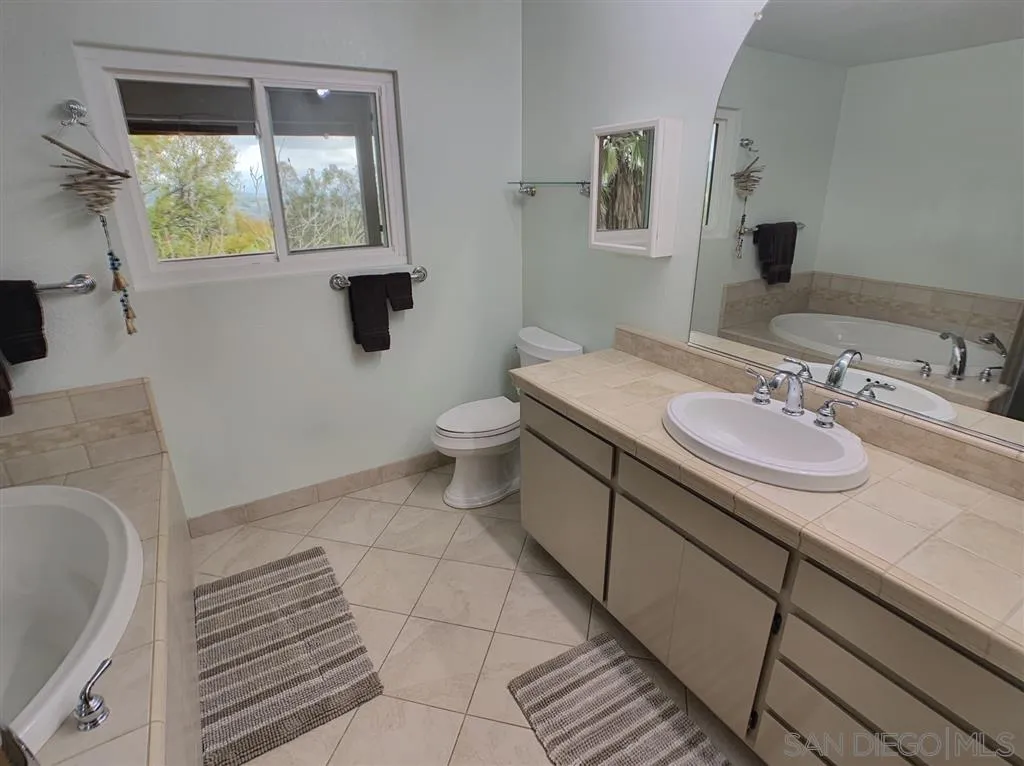 21152 Sutherland Dam Road Ramona, CA 92065 - Photo 14 of 25 a bathroom with a sink and a mirror