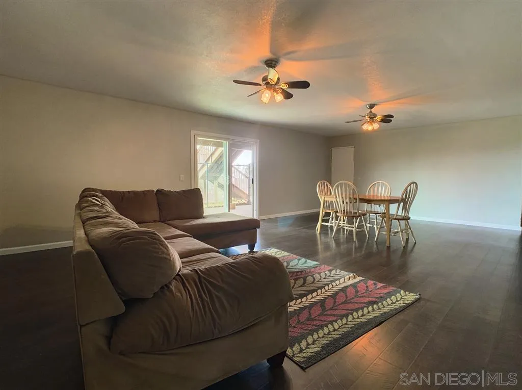 21152 Sutherland Dam Road Ramona, CA 92065 - Photo 20 of 25 a living room with furniture and a chandelier