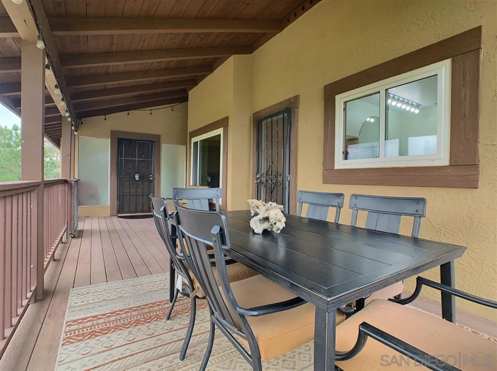 21152 Sutherland Dam Road Ramona, CA 92065 - Photo 22 of 25 a view of a dining room with furniture and wooden floor