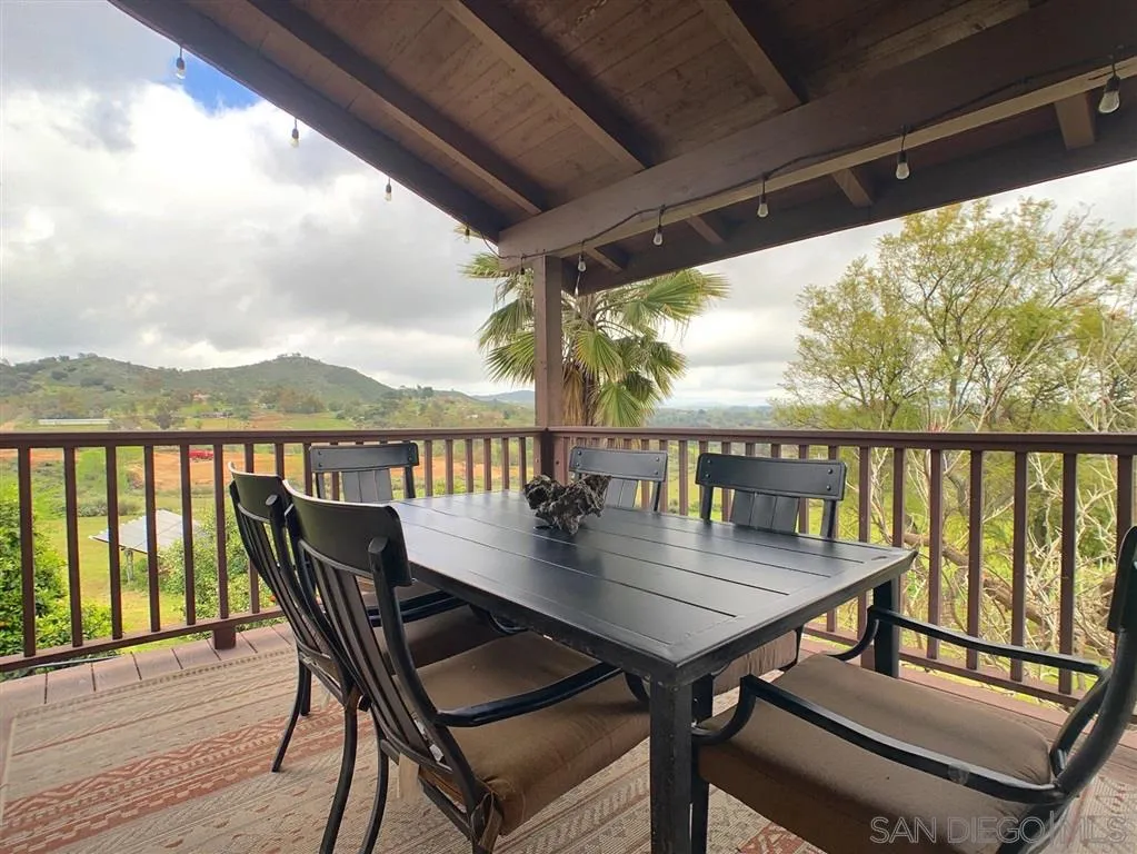 21152 Sutherland Dam Road Ramona, CA 92065 - Photo 24 of 25 a view of a balcony with furniture and wooden floor