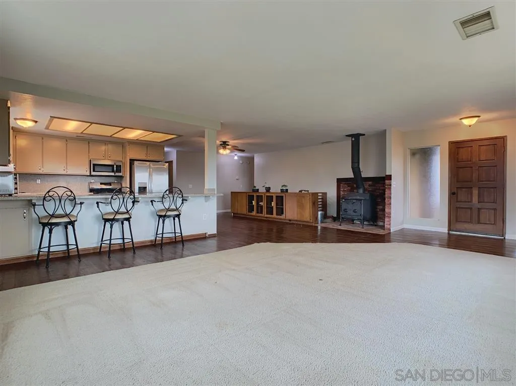 21152 Sutherland Dam Road Ramona, CA 92065 - Photo 5 of 25 a view of a livingroom with furniture and a kitchen