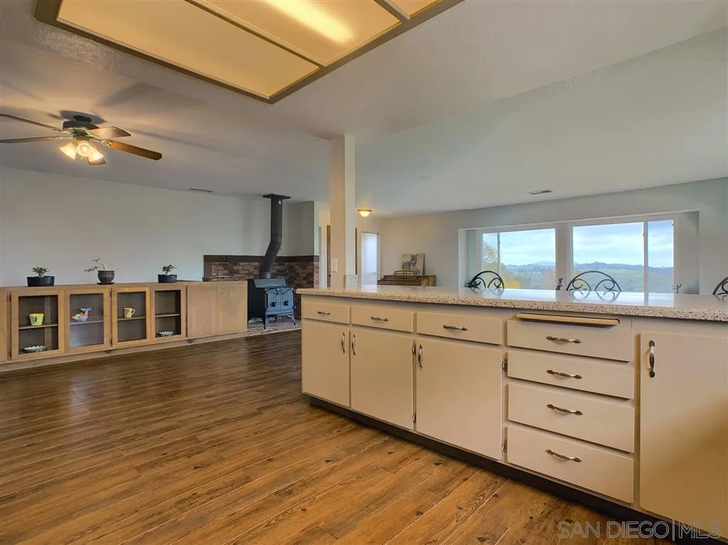 21152 Sutherland Dam Road Ramona, CA 92065 - Photo 7 of 25 a kitchen with stainless steel appliances granite countertop a stove and a wooden floors