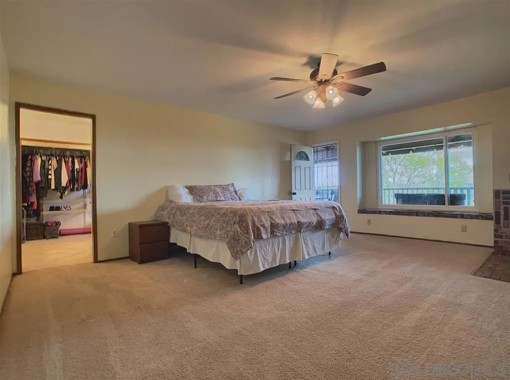 21152 Sutherland Dam Road Ramona, CA 92065 - Photo 9 of 25 a bedroom with a bed and window