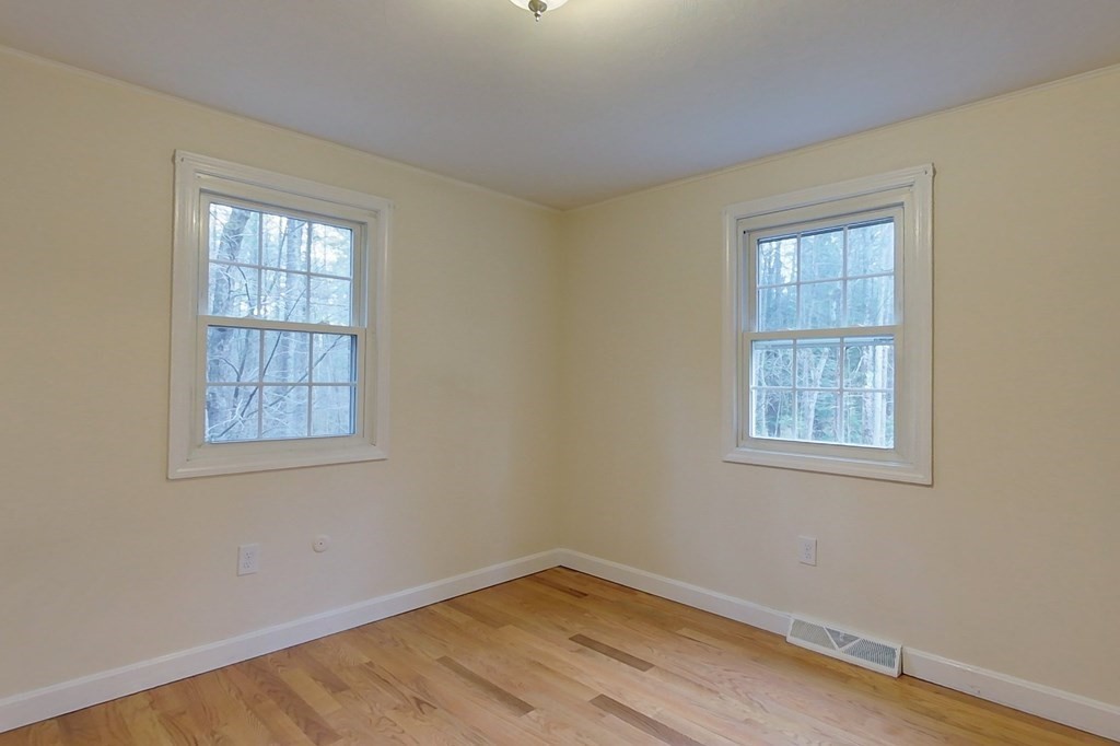 5 Peach Lane Townsend, MA 01469 - Photo 13 of 32 a view of an empty room with wooden floor and a window