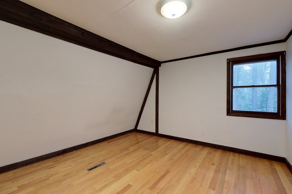 5 Peach Lane Townsend, MA 01469 - Photo 18 of 32 a view of an empty room with wooden floor and window