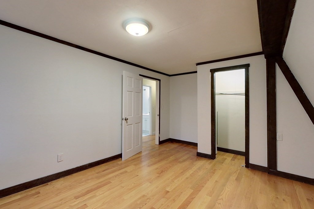 5 Peach Lane Townsend, MA 01469 - Photo 19 of 32 an empty room with wooden floor and entrance
