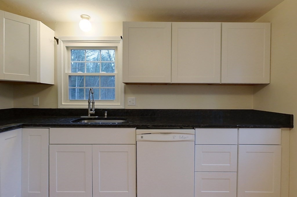5 Peach Lane Townsend, MA 01469 - Photo 3 of 32 a kitchen with granite countertop white cabinets and a sink