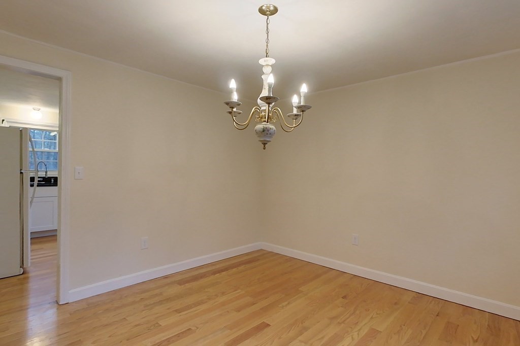 5 Peach Lane Townsend, MA 01469 - Photo 5 of 32 a view of a room with wooden floor and chandelier