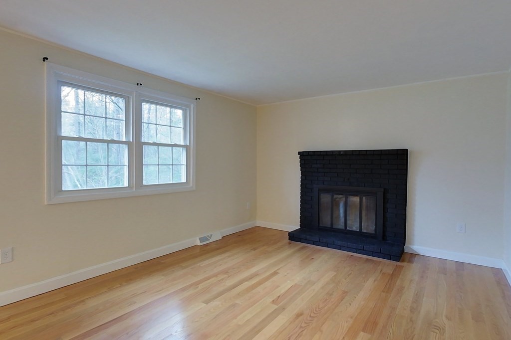 5 Peach Lane Townsend, MA 01469 - Photo 9 of 32 a view of an empty room with wooden floor and a window