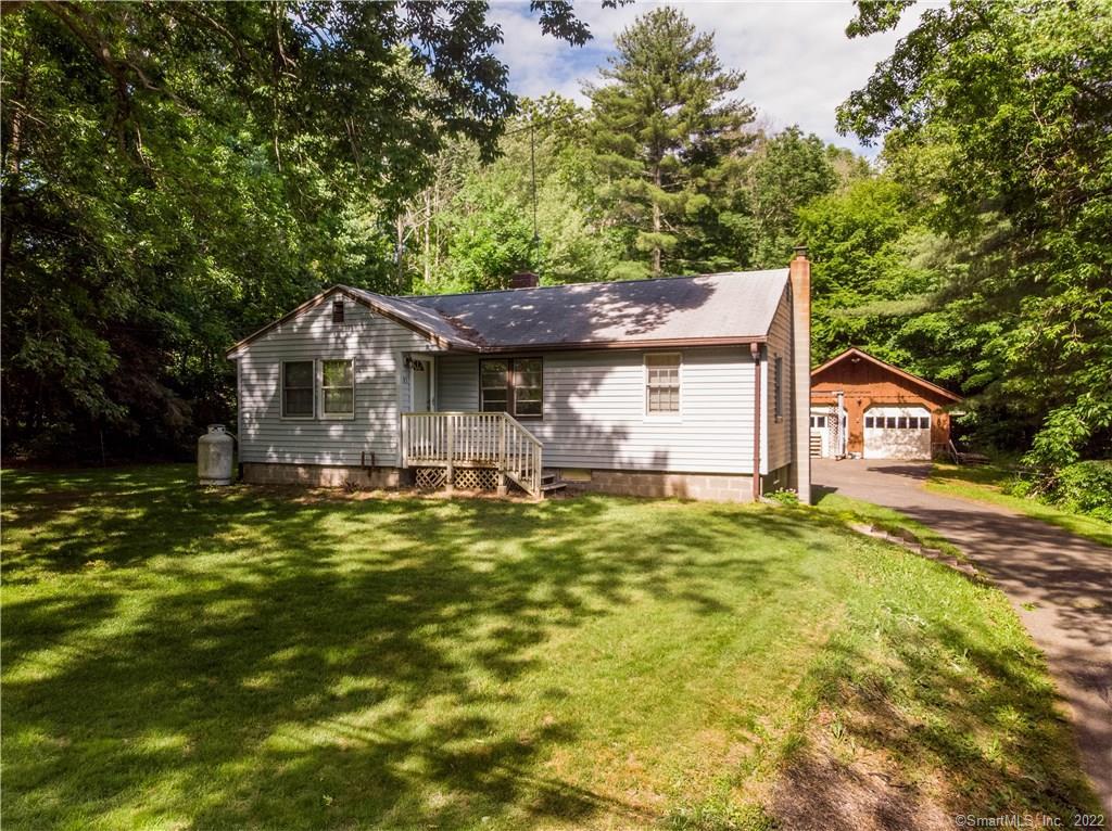 93 Leonard Road Stafford, CT 06076 - Photo 1 of 1 a front view of a house with a yard garage and outdoor seating
