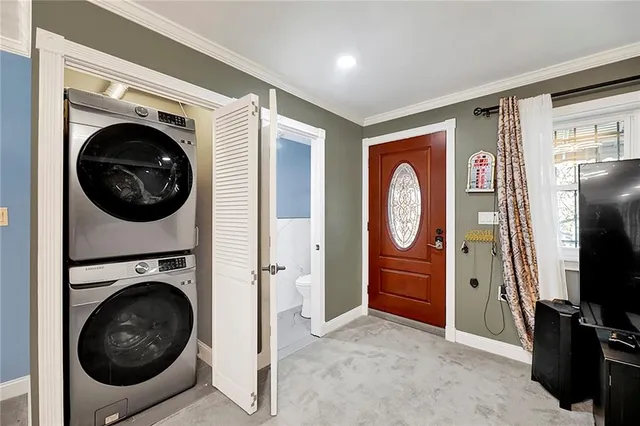 a view of a bedroom with washer and dryer