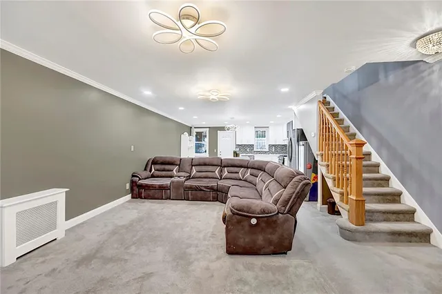 a living room with furniture and stairs