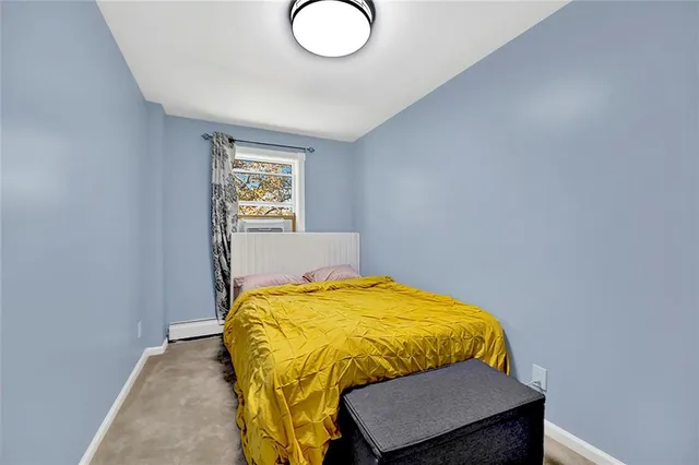 a bed sitting in a bedroom next to a window