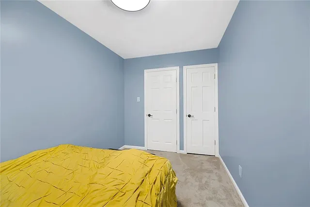 a bedroom with a bed and a lamp