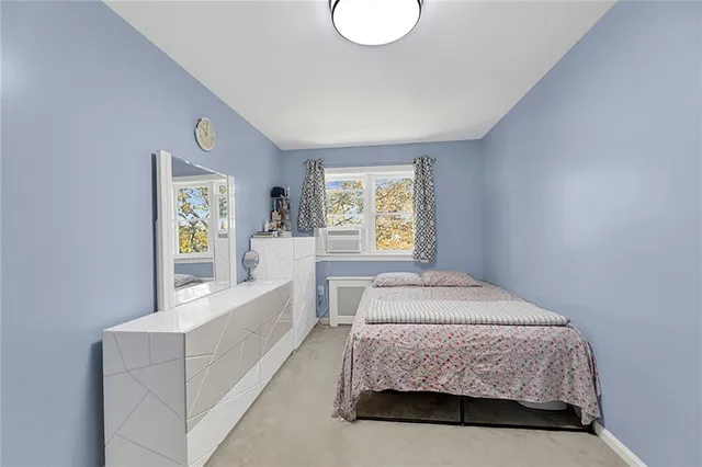 a spacious bedroom with a bed and window