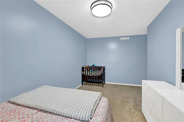 a bedroom with a bed and a table in it