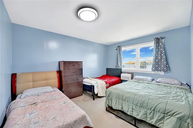 a bedroom with two beds and a window