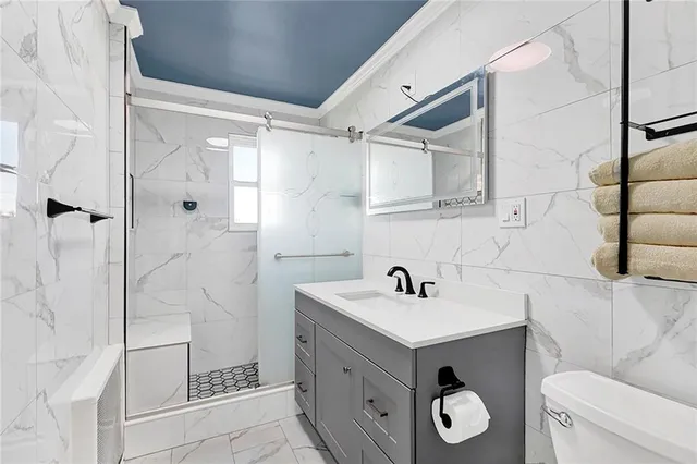 a bathroom with a sink a toilet and shower