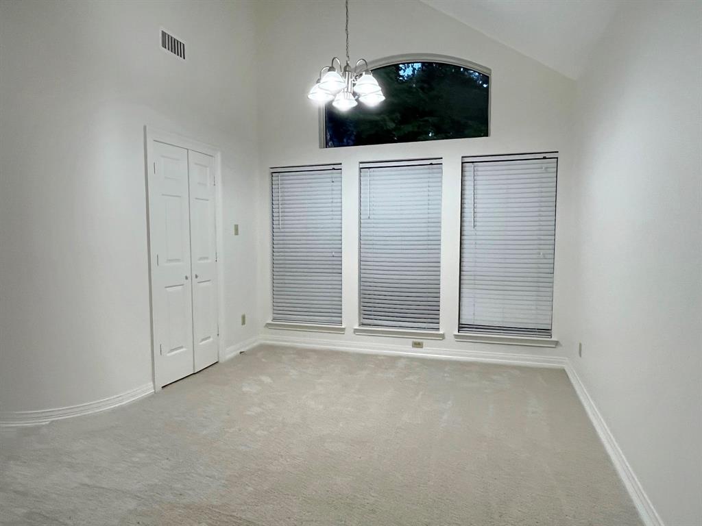 1840 Wind Hill Road Rockwall, TX 75087 - Photo 11 of 28 a view of an empty room with a fireplace and a chandelier fan