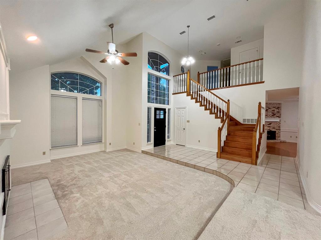1840 Wind Hill Road Rockwall, TX 75087 - Photo 12 of 28 an empty room with staircase and ceiling fan