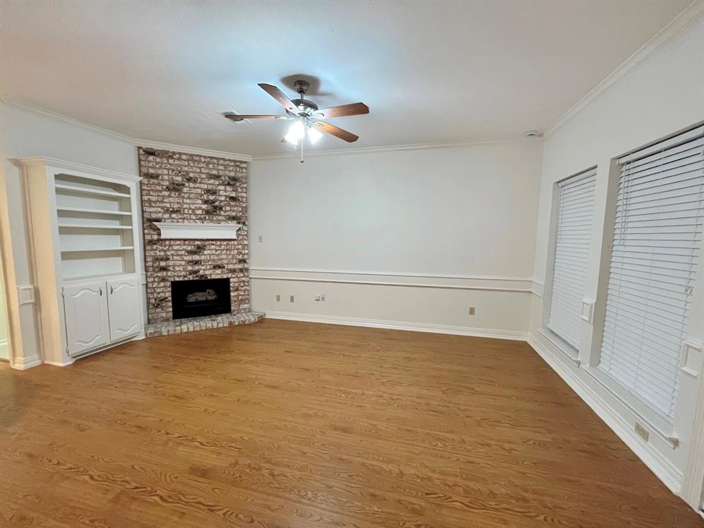 1840 Wind Hill Road Rockwall, TX 75087 - Photo 15 of 28 a view of empty room with a fireplace and fan