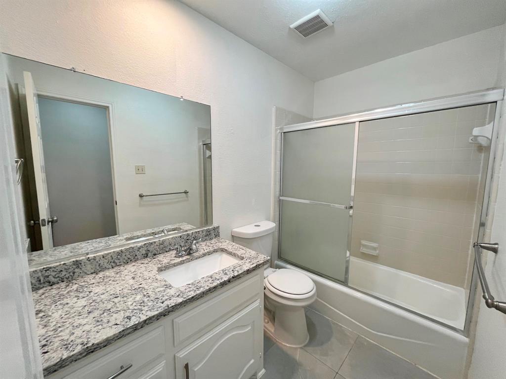 1840 Wind Hill Road Rockwall, TX 75087 - Photo 22 of 28 a bathroom with a granite countertop sink toilet and shower