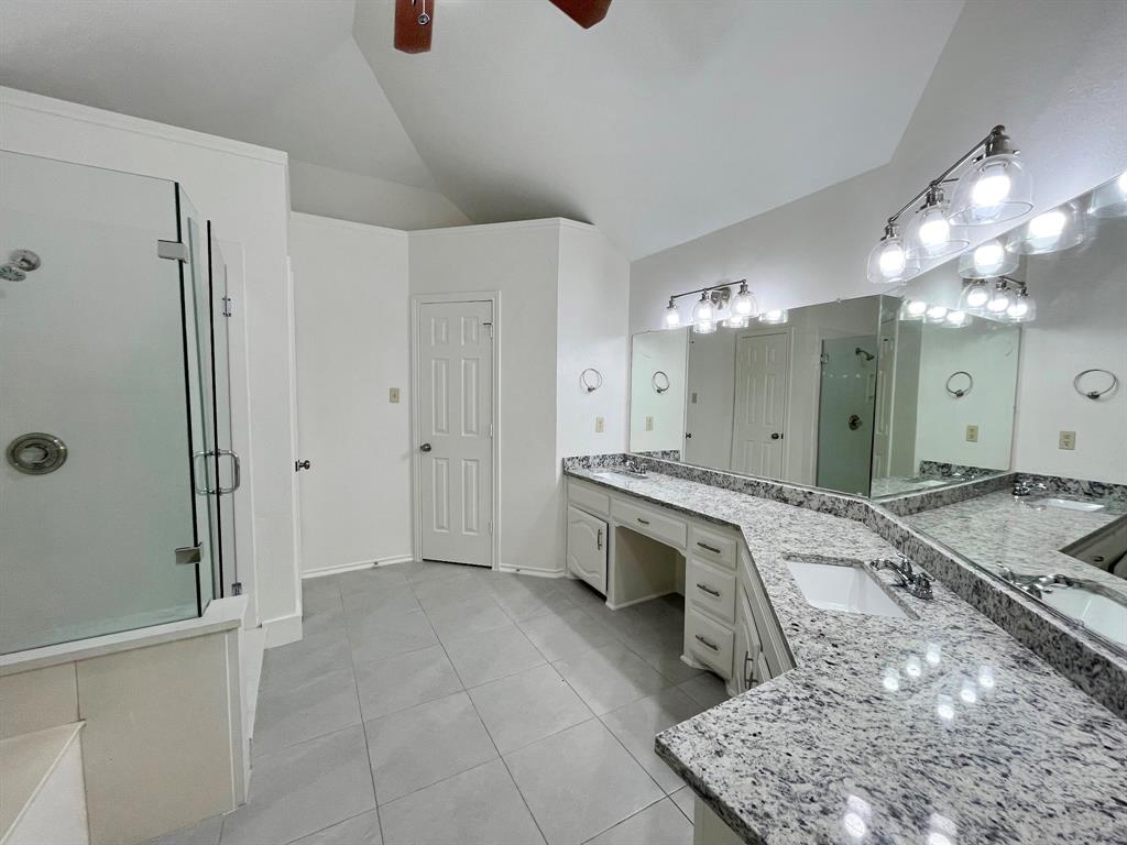 1840 Wind Hill Road Rockwall, TX 75087 - Photo 24 of 28 a spacious bathroom with a double vanity sink mirror and shower