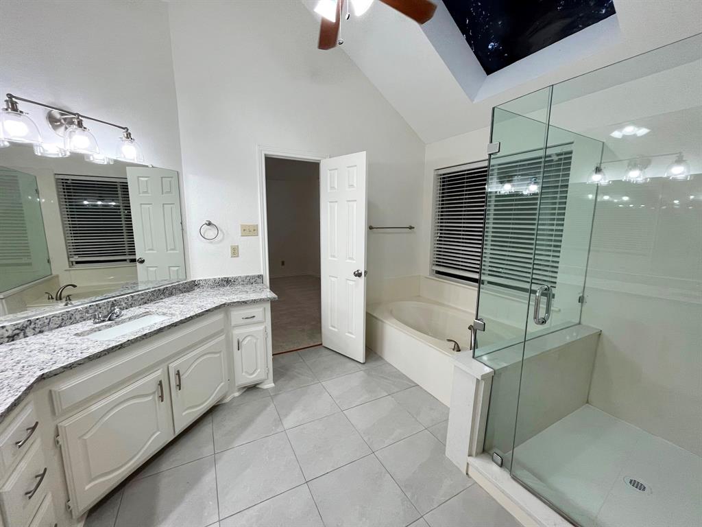 1840 Wind Hill Road Rockwall, TX 75087 - Photo 25 of 28 a bathroom with a tub sink and mirror