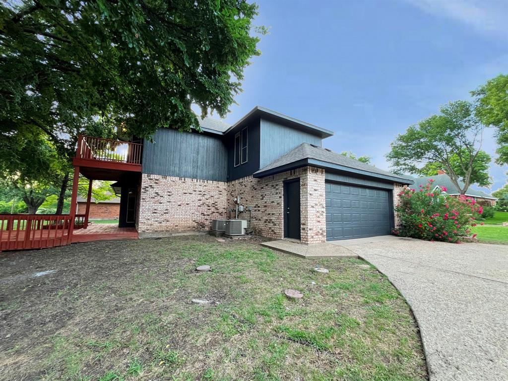 1840 Wind Hill Road Rockwall, TX 75087 - Photo 27 of 28 a front view of a house with a yard and garage