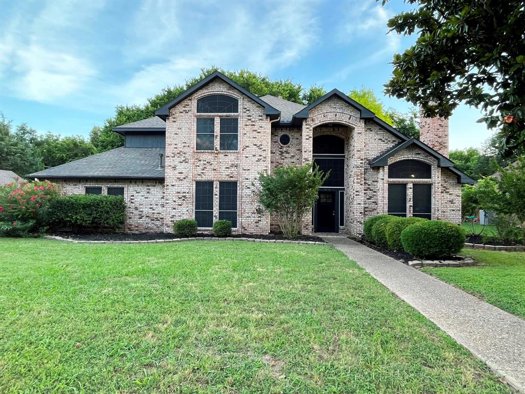 1840 Wind Hill Road Rockwall, TX 75087 - Photo 3 of 28 a front view of a house with a yard and garage